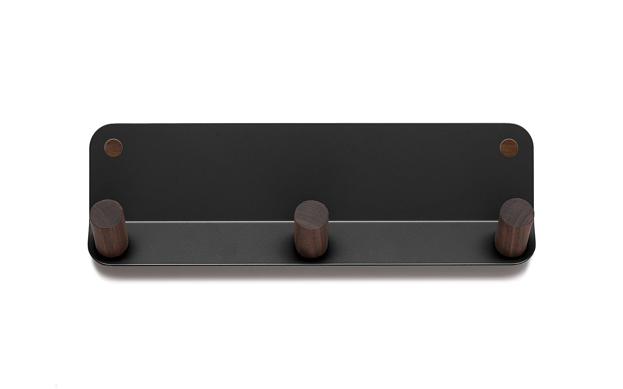 The Plane 3 Wall Hook by Fire Road is a black, wall-mounted coat rack featuring three round wooden hooks and a sleek powder-coated steel frame.