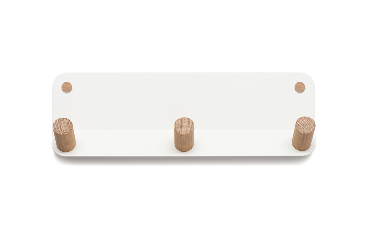 The Plane 3 Wall Hook by Fire Road is a white rectangular wall-mounted coat rack featuring three wooden pegs on a powder-coated steel frame.