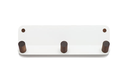 The Plane 3 Wall Hook from Fire Road is a white wall-mounted coat rack crafted from powder-coated steel and featuring three wooden pegs.