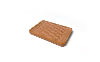 A Deco Soap Dish by Fire Road with a wavy, carved pattern on the surface, placed on a white background, perfect as an eco-friendly soap dish.